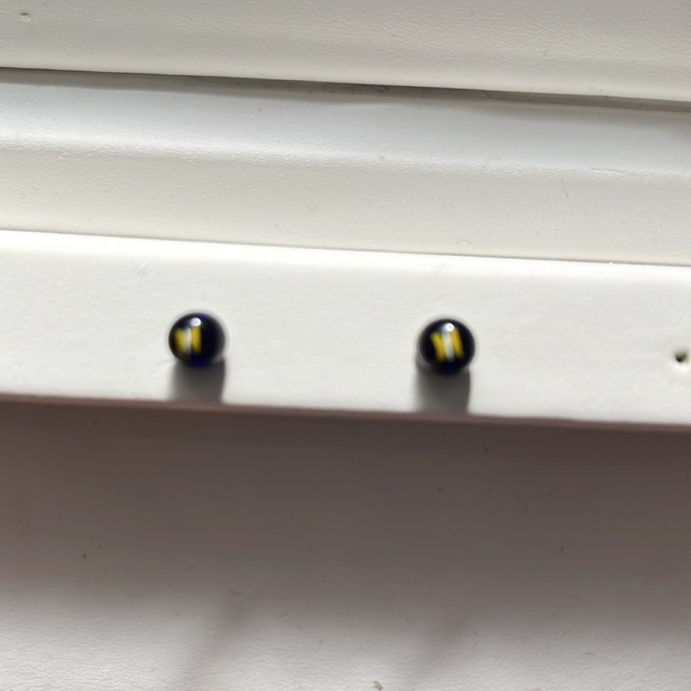 Dark purple studs with small yellow and white butterflies